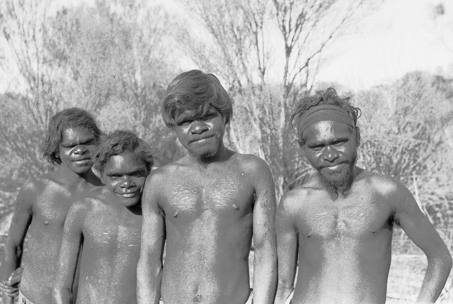 Tom Underwood, Bill Jamieson, Roy Underwood, Roger Jamieson after being ‘found’ on Spinifex Country, now called the Great Victoria Desert. In the early 1950s, many of the Spinifex People were still living traditional lifestyles deep in the remote desert; this was the first meeting with white people. Roy Underwood would eventually become an internationally recognised artist and would travel the world to tell the story of his people through art.