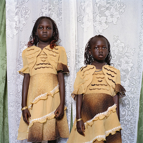 Two young Sudanese girls in formal dress