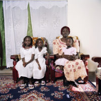Sudanese girls in matching white dress with mother