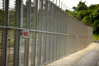 Colour photo of fence around Christmas Island Detention Centre