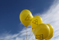 Yellow balloons with slogan: 'Farms not gas'.