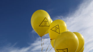 Yellow balloons with slogan: 'Farms not gas'.