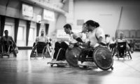 Black and white photo of a men's wheelchair rugby match