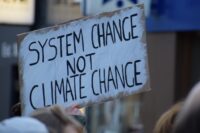 Protest sign reads System change not climate change